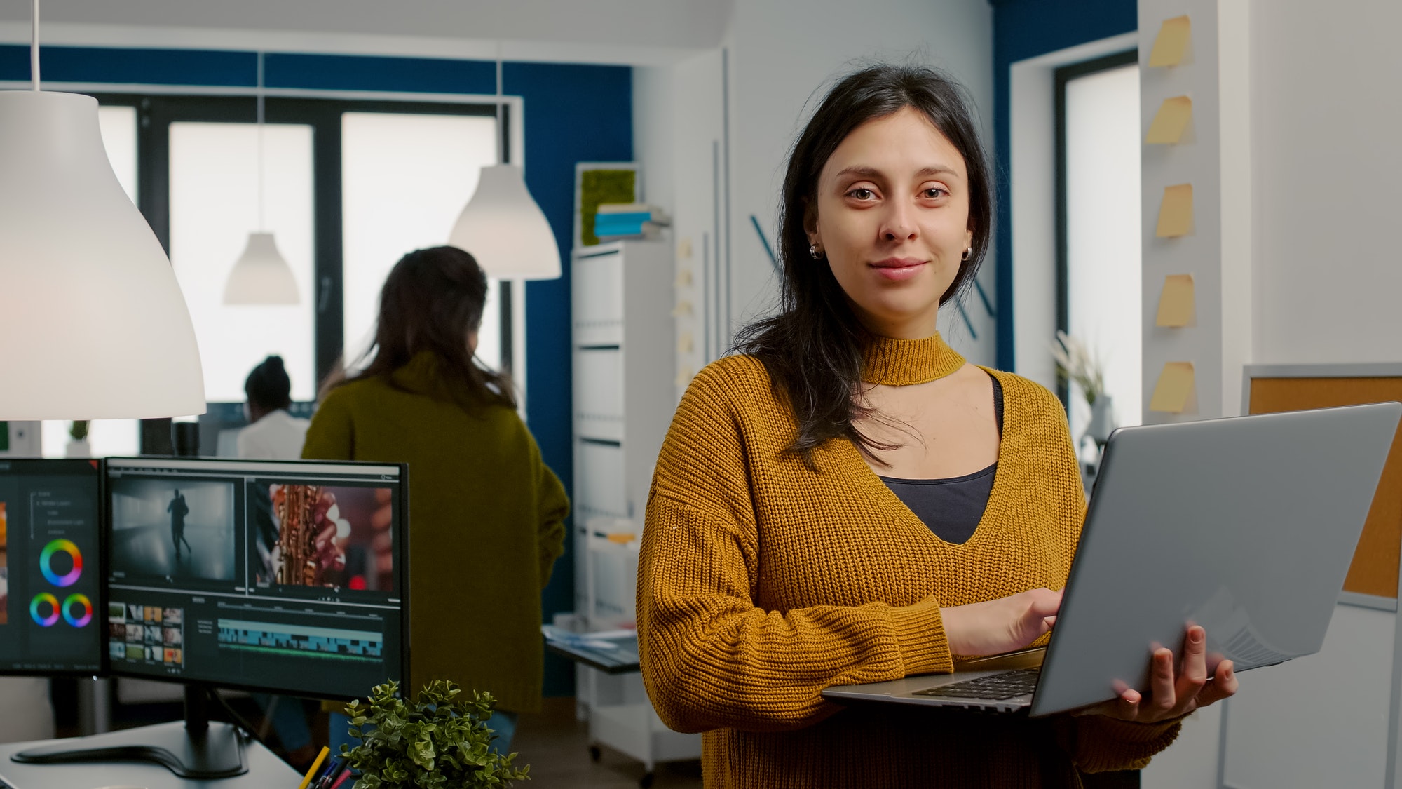 woman-retoucher-looking-at-camera-smiling-working-in-creative-media-agency.jpg